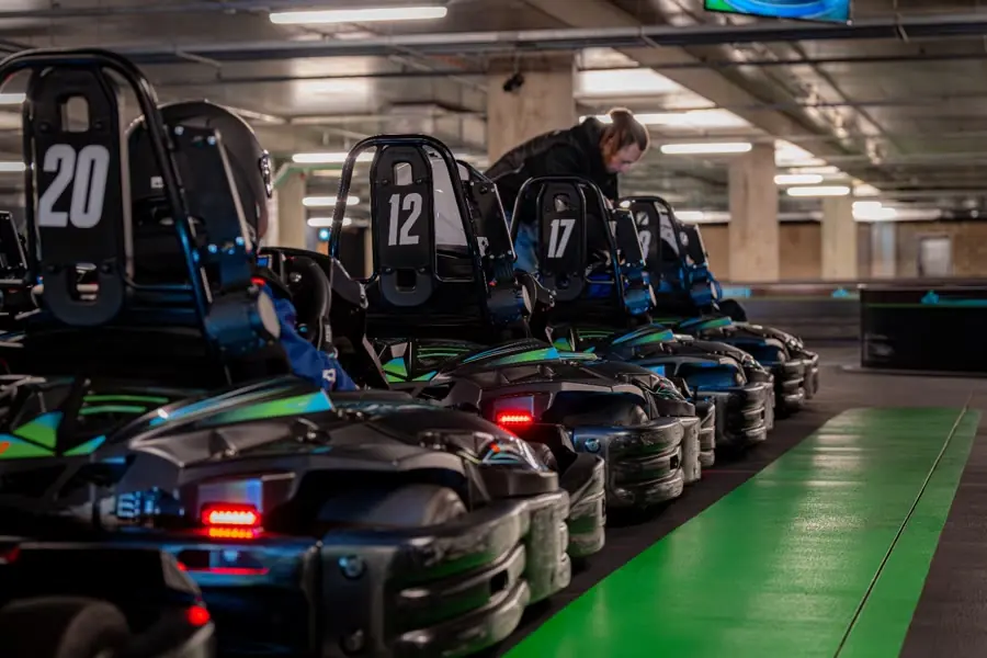 A row of Motorcity electric karts in the pit lane